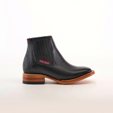 The Napa Black Square Toe ankle boot boasts luxury craftsmanship with a genuine leather finish, a square toe, and wooden sole. It features elastic ribbed sides, a red inner lining, Texana Country stitched tag, and a dark-layered heel for added elegance.