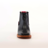 The Napa Black Square Toe boot features a genuine leather front view, a brown sole, and red accents at the top. Displayed on a simple light background, this boot exemplifies luxury craftsmanship.