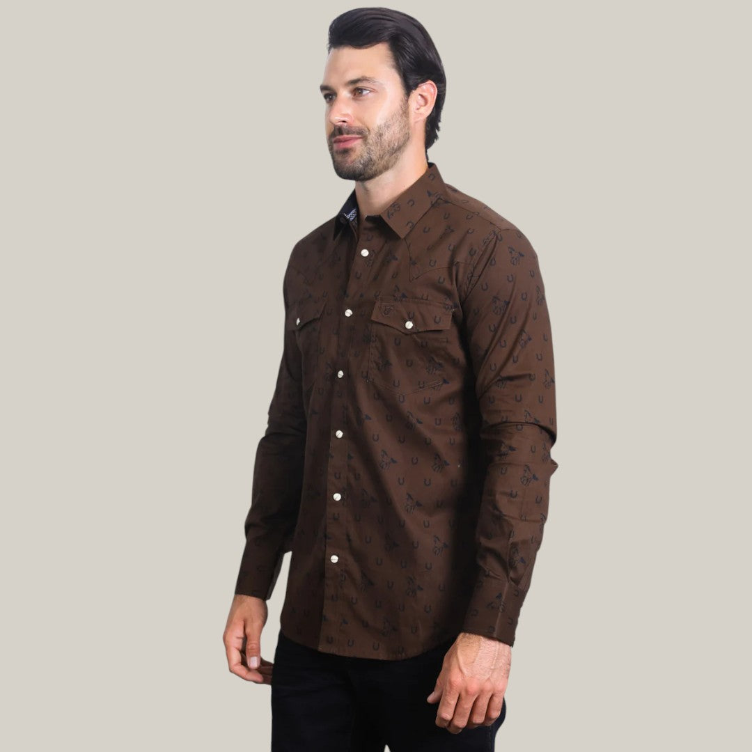 A man with dark hair and a beard confidently wears the WPL10487 Mens Western Modern Fit Spandex Long Sleeve Brown Shirt with Snaps, featuring a subtle black print, paired with black pants against a plain light gray backdrop.