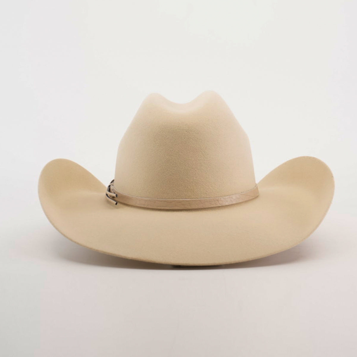 The 6X Chihuahua Bone is a premium Western hat made from Chihuahua felt in a beige tone, featuring a curved brim and light brown band, displayed against a plain white background.