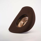 The 6X Chihuahua Brown, a premium sheep wool cowboy hat, is shown from an angle to highlight the inside band and design details. Crafted with care, this Western hat stands upright against a plain white background.