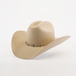 The 6X Country Bone, a beige felt cowboy hat made from soft sheep wool, is decorated with a metal concho band. This Western classic features a wide brim and pinched crown, elegantly set against a plain white background.