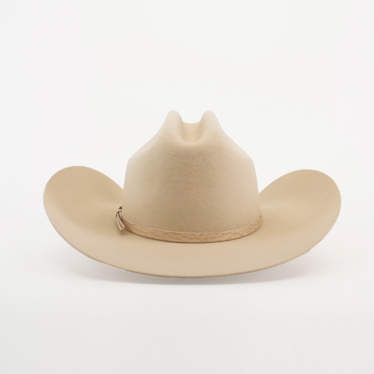 The 6X Country Bone is a classic Western-style tan cowboy hat with a wide brim and crease, crafted from fine felt. It features a light brown band around the base and is showcased on a plain white background.