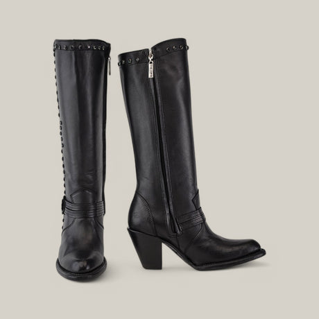 From the Denali Crystals Collection, these knee-high leather boots feature a tall shaft with block heels and studded detailing. A side zipper closure enhances their chic design, with one boot upright and the other angled for artistic flair.