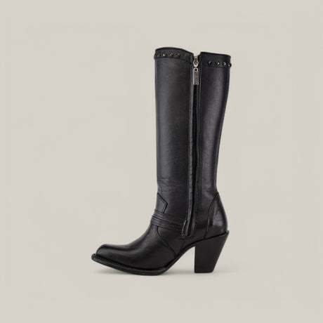 The Denali Crystals Tall Shaft Black - Round Toe boot features a knee-high black leather design with a chunky heel, decorated with studs near the top. A side zipper adds functionality, all set against a light-colored background.