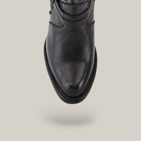 The Denali Crystals Tall Shaft Black - Round Toe shoe from the Platinum Collection, visible on a light gray background, showcases its classic design with a rounded toe and highlighted stitching on the sole.