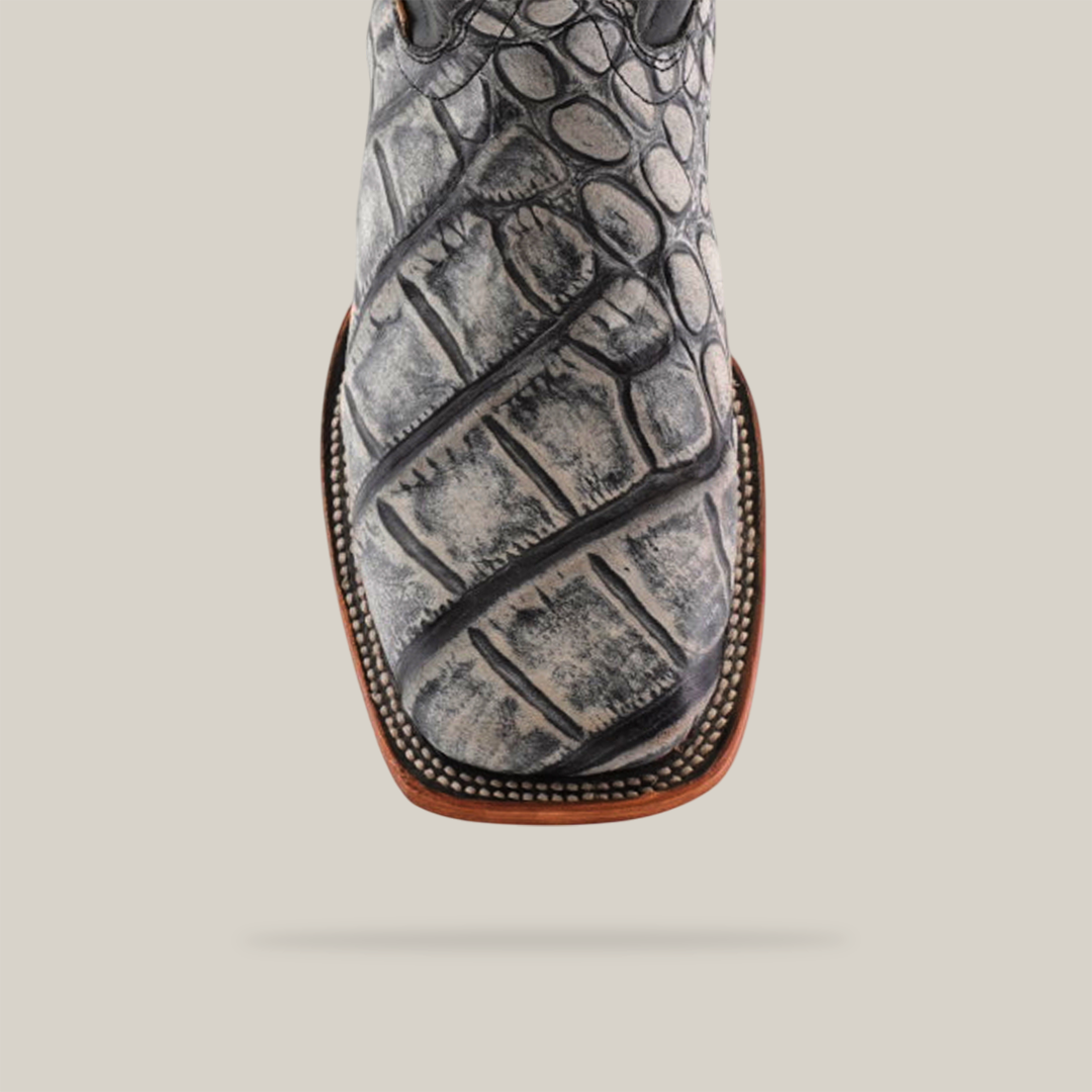 Close-up of the American Alligator Print Rustic Black - Square Toe cowboy boot in gray and black with intricate stitching, a brown sole, and set against a plain white background.