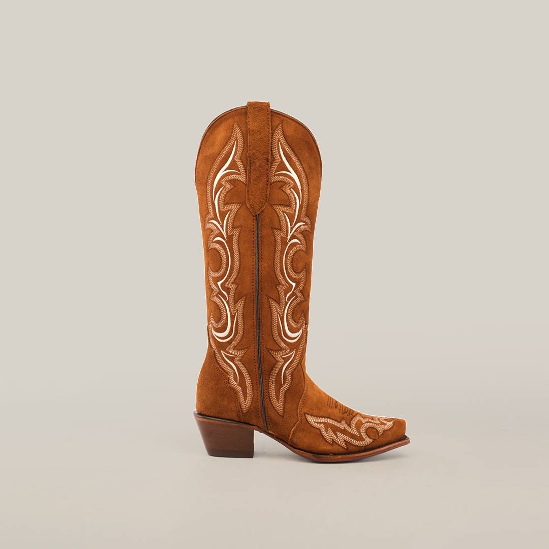 The Amara Tabaco Suede - Tall Shaft - Snip Toe cowboy boot exudes luxury with its intricate white stitching and womens fashion-forward design, featuring a mid-height heel and slightly pointed toe against a plain white background.