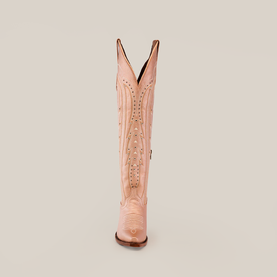 A single pink cowboy boot stands upright on a white background, featuring decorative stitching and cutouts. Its snip toe and raised heel echo the elegance of the Sara Metallic Florentine - Tall Shaft, while the V-shaped opening adds a unique touch.