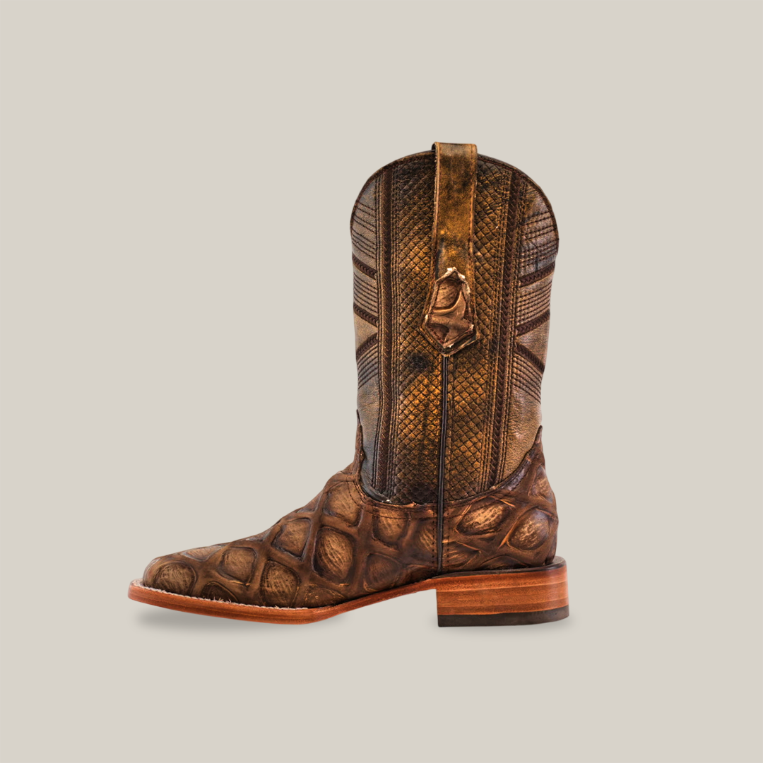 The Big Bass Pirarucu Print Rustic Orix is a brown cowboy boot featuring a textured pirarucu print pattern, a high shaft with pull tabs, and square toes. It has a stacked heel and is showcased against a plain white background.