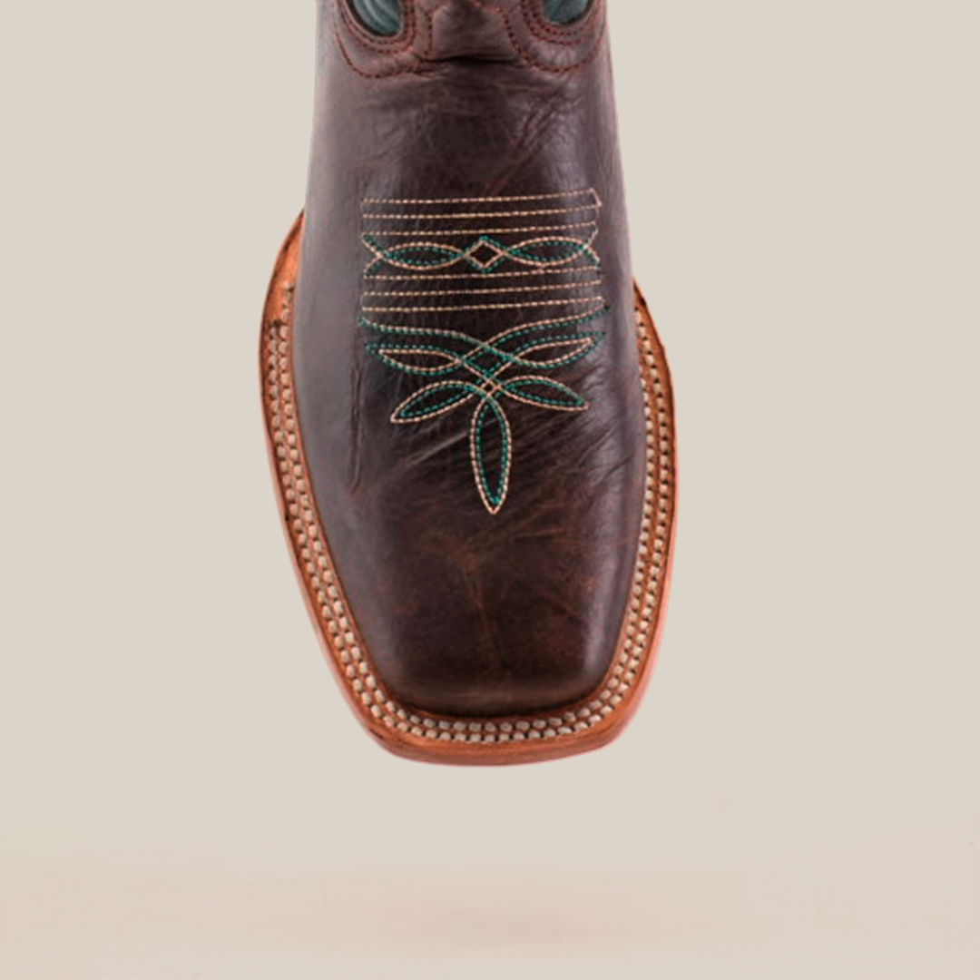 A close-up of the Grecas Brown - Short Shaft - Square Toe boot highlights its traditional craftsmanship with intricate green and gold stitching on the square toe, decorative sole edging, all set against a crisp white background.