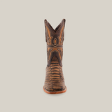 A single brown Jumbo Python Print Camel boot in premium cowhide leather, with intricate stitching and a square toe, is centered against a plain white background. The design features textured patterns on the upper and toe, complemented by a sturdy wooden sole.