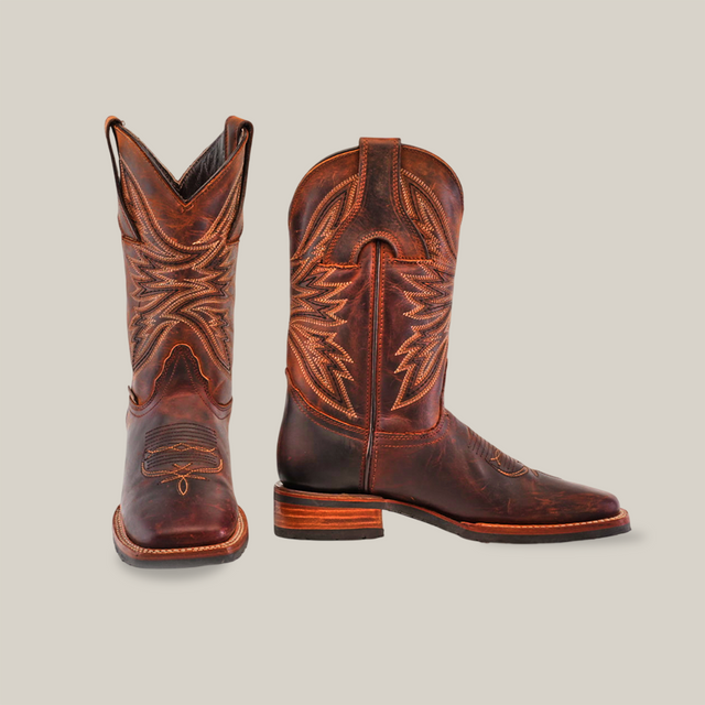 Azkar Moka cowhide leather cowboy boots, featuring intricate stitching and a slip-resistant wooden sole, are displayed against a plain beige background. One boot is forward-facing while the other is in profile.