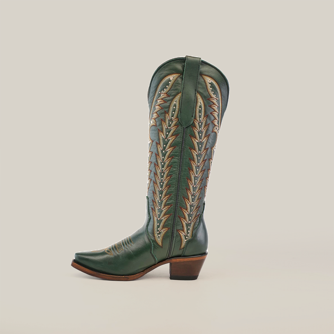 The Madona Forest Green cowboy boot features premium leather with intricate brown stitching on the tall shaft, a snip toe, and a mid-height heel, all displayed against a plain white background.