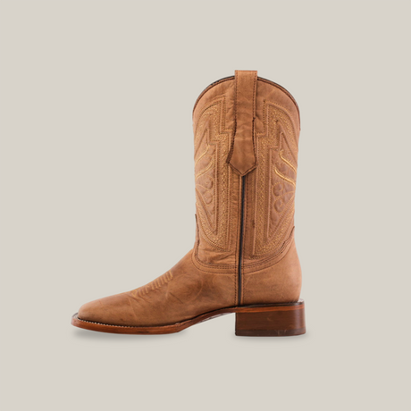 The Sierra Fawn - Square Toe cowboy boot, handcrafted from premium cowhide leather, features intricate shaft stitching and a sturdy wooden heel. Displayed elegantly against a plain, light background, it embodies style and durability.