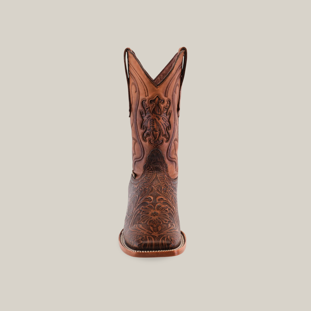 The Handtooled Leave Brown - Square Toe cowboy boot, crafted from premium cowhide leather, features intricate embroidery and patterns. Its striking design is showcased from the front against a white background.