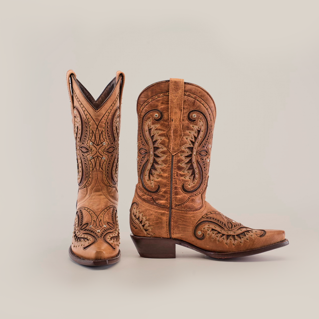 A pair of handcrafted Croella Fawn Crystals boots, short shaft with a snip toe, showcases intricate embroidery and subtle crystals. One boot is upright while the other tilts to reveal its side design on a white background.