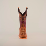 The Grecas Orix cowboy boot, with its narrow square toe, boasts a brown leather exterior adorned with decorative foot stitching and floral upper patterns. Its short shaft combines dark brown and purple leather, showcased upright against a plain white background.