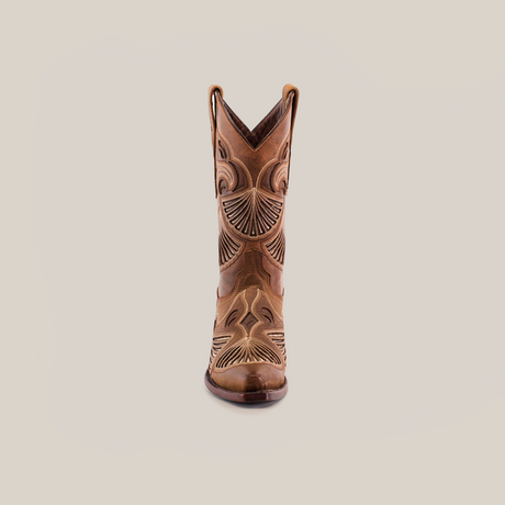 The Shan Camel Short Shaft showcases intricate stitching and Western style in a single brown leather boot with decorative designs and a snip toe, all set against a white backdrop.