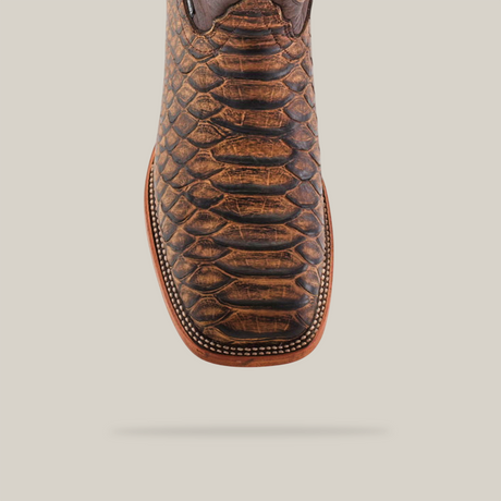 Close-up of the Jumbo Python Print Camel - Square Toe boot crafted from premium cowhide leather with a snakeskin-like pattern and detailed toe stitching, photographed against a light background, showcasing its style and quality.