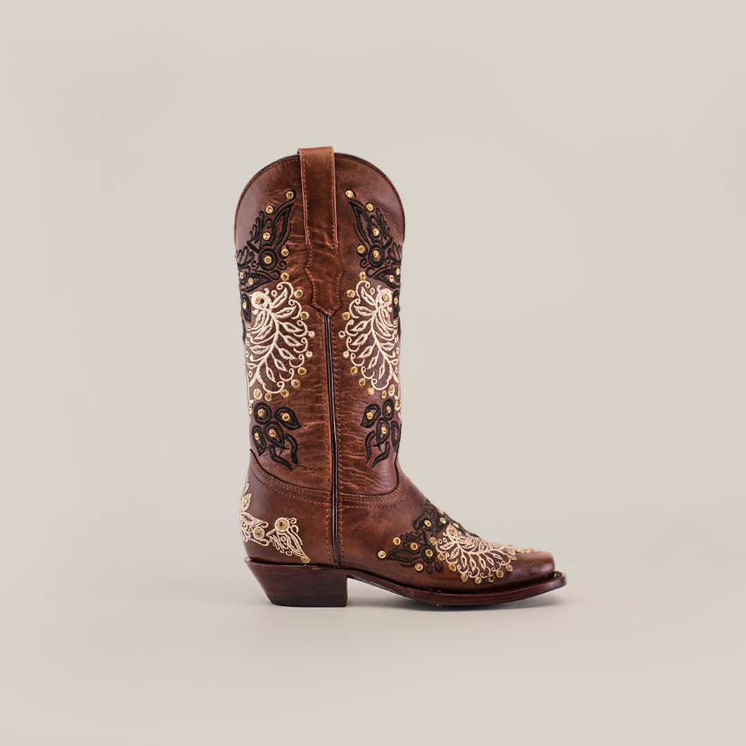 A single handcrafted Faenza Crystals Brown boot, featuring premium leather with intricate white and black embroidery, decorative studs, and floral patterns on the shaft and foot, displayed on a neutral background.