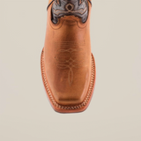 Top view of a Cater Honey Slip Resistant Sole Rodeo Toe Boot made from premium leather with intricate stitching on the toe and upper. It features a square toe and decorative patterns, set against a plain white background.