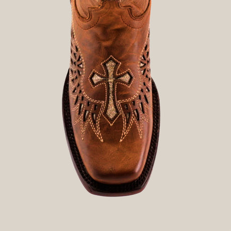 The Texas Cross Glitterbomb Camel boots are brown leather cowboy boots with intricate stitching, chic glitter details, and a decorative cross on the toe. Featuring cut-out designs, a dark sole, and premium leather on a light background with a mid shaft and narrow square toe.