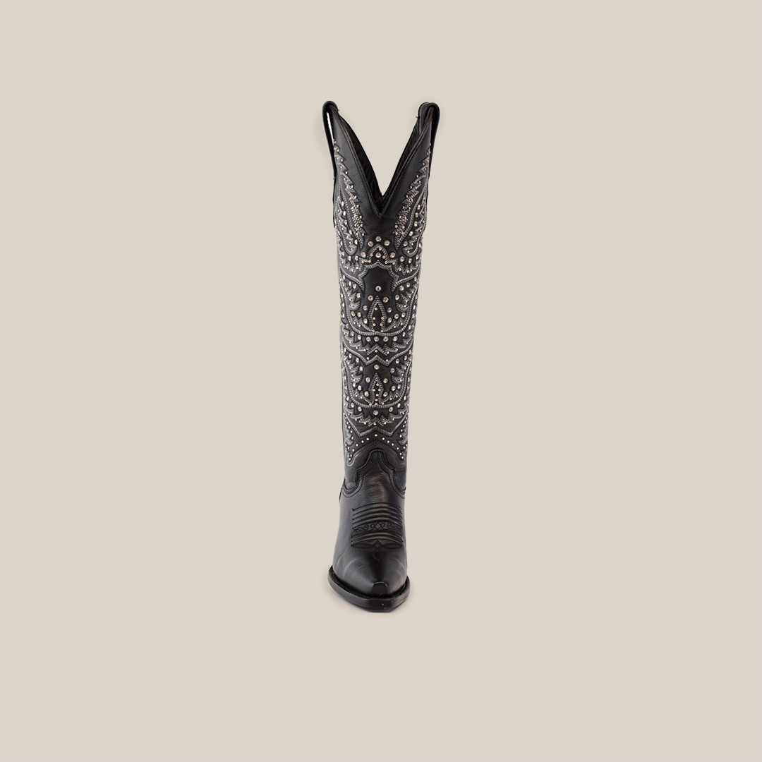 The Crystals Wings Black Lustre boot is a black cowboy masterpiece with intricate white stitching and decorative patterns. Handcrafted with a premium leather sole, it features a snip toe and tall shaft, elegantly showcased against a plain white background.