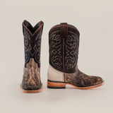 A pair of Cowhide Hair Fawn Square Toe boots features cowhide hair texture on the lower part, intricate white stitching on the dark brown upper; one boot is upright, and its sideways counterpart displays a square toe design, wooden heel, and back.