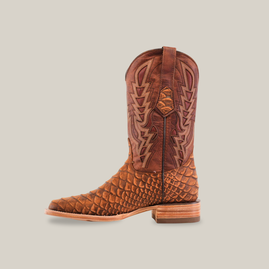 A single Jumbo Python Print Cogñac - Square Toe cowboy boot, in brown with an intricate stitched design, stands against a white background. It features a square toe, thick heel, and side pull straps, crafted from premium cowhide leather for both durability and style.