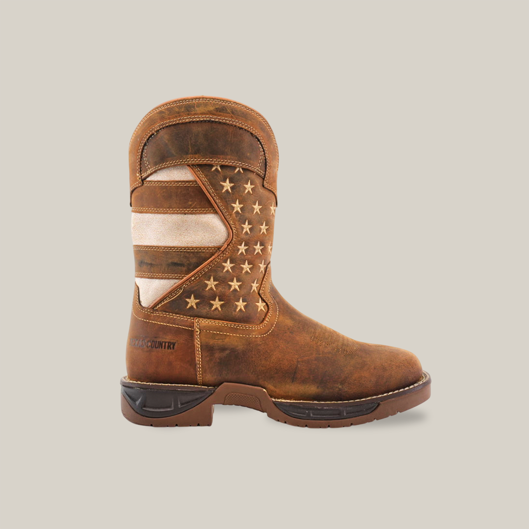 The White Tan US Flag - Waterproof - Soft Toe boot is handcrafted from cowhide leather, showcasing an American flag design with tan and white stripes and stars on a dark background, complete with a thick, durable dark brown sole.