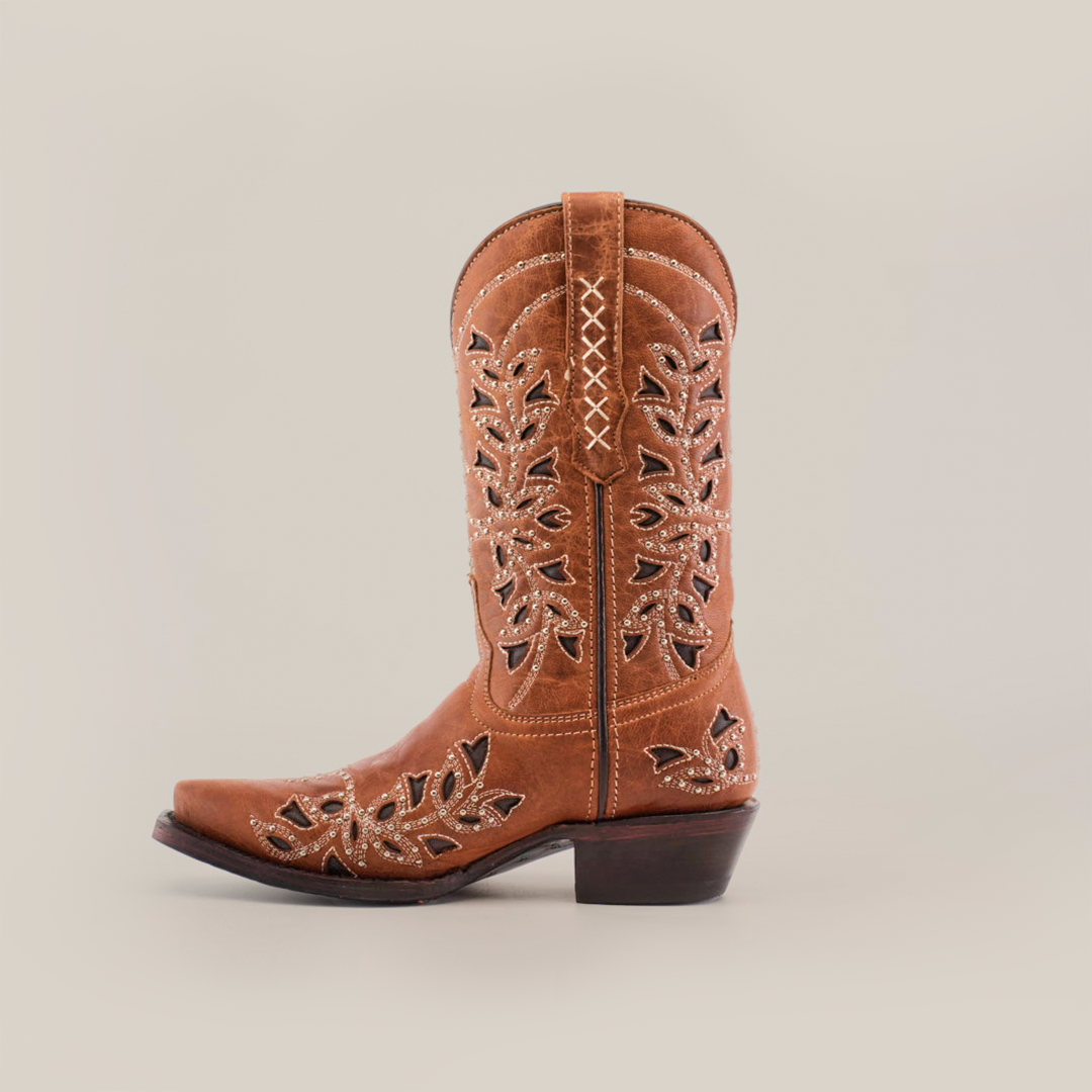 The Flipy Honey - Short Shaft - Snop Toe boot, shown sideways on a white background, boasts decorative leaf-shaped cutouts and white stitching. With traditional craftsmanship, it includes a premium leather sole, low heel, and pointed toe. An ideal addition to womens boots collections.