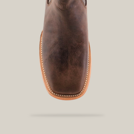 Close-up of the Alamo Brown Square Toe, showcasing its handcrafted design with tan stitching along the edges. This Western fashion piece stands out against a white background.