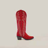 The Amara Red Suade - Tall Shaft boot features intricate white stitching on red suede leather, a snip toe, and a black heel, all set against a clean white background.