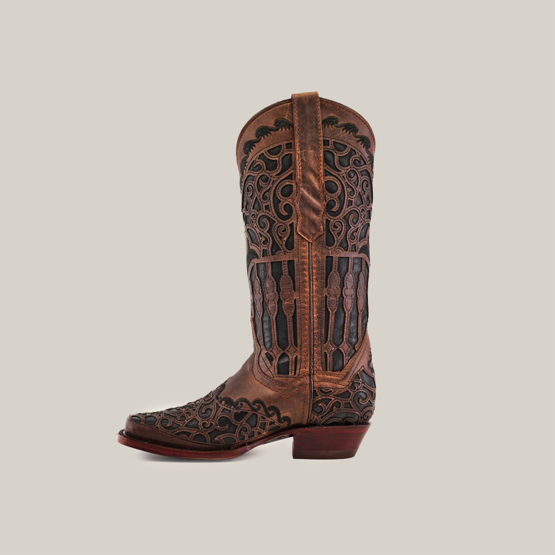 The Taurine Chocolate Mid Shaft boots, named for their narrow square toe, are handcrafted luxury cowboy boots made from premium leather with intricate black embroidery. They feature a low heel and stand proudly against a plain white background.