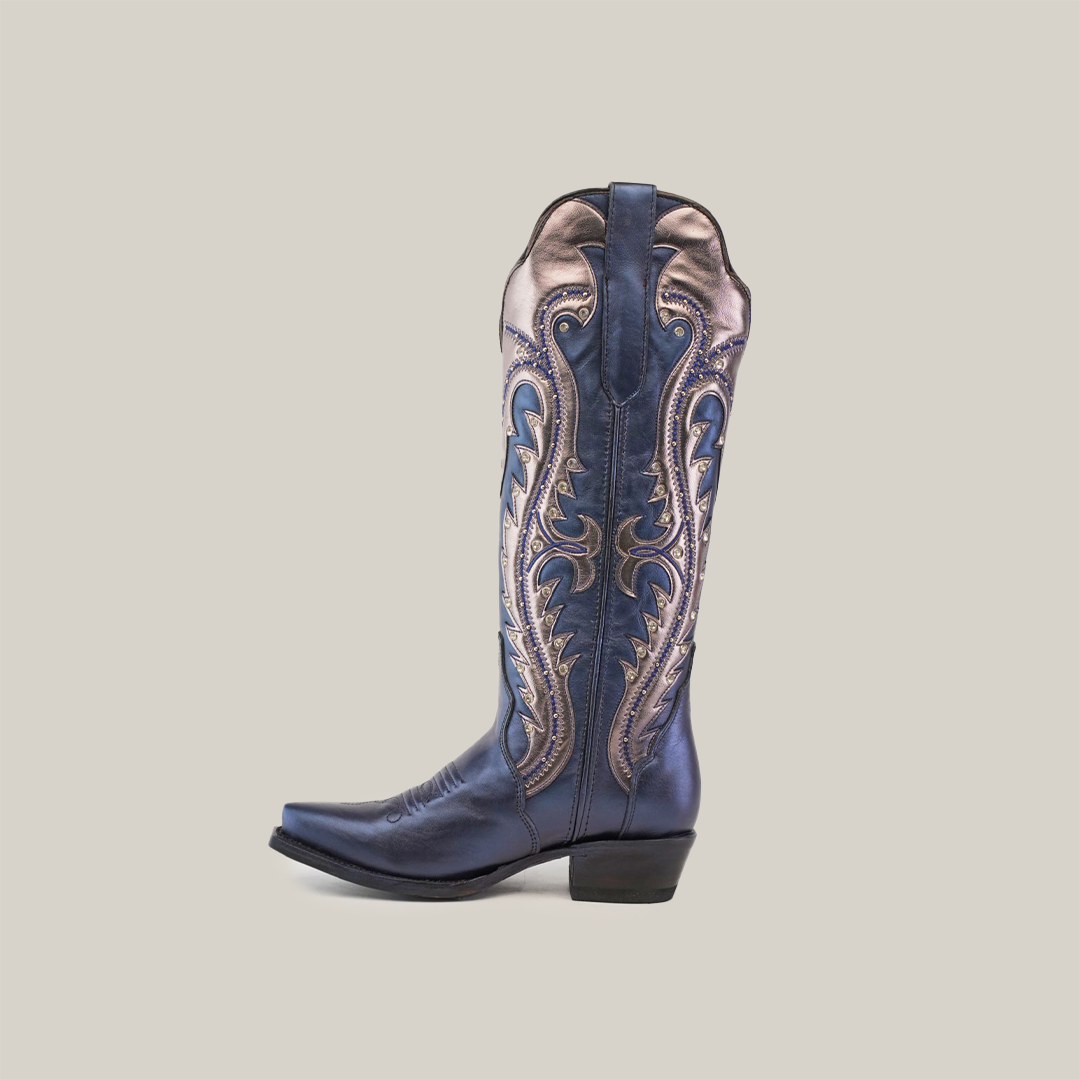 The Valentina Navy Tall Shaft boot, featuring a snip toe and intricate silver embroidery, embodies Western craftsmanship against a simple white background.