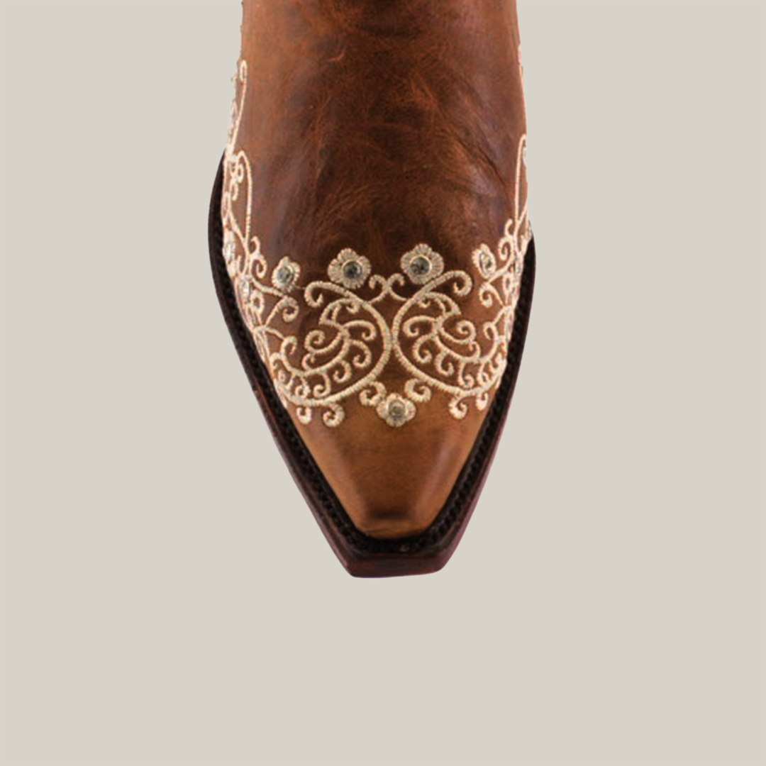 Top view of the Albine Crystals Camel mid-shaft cowboy boot featuring premium leather, intricate white floral and swirl embroidery on the snip toe, enhanced with crystal embellishments for an elegant decorative pattern showcasing true luxury craftsmanship.