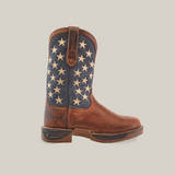 A brown cowboy boot made from premium cowhide leather has a dark blue shaft with white stars. The Navy Brown US Flag - Waterproof - Soft Toe offers a sturdy sole, intricate stitching, and features the brands embossed name. The background is plain white.