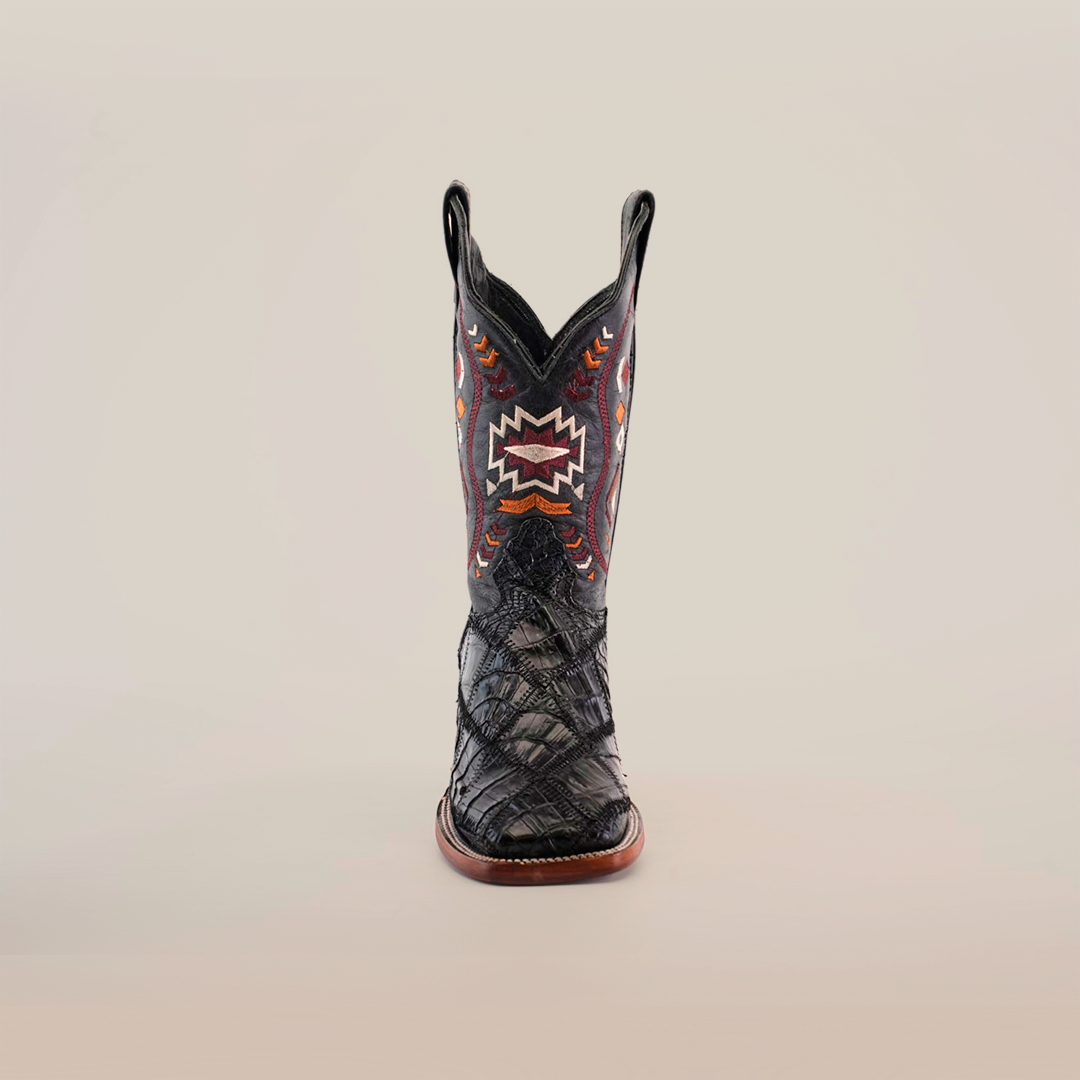 The Exotic American Alligator Patchwork Black Square Toe boot showcases a variety of textures and multicolored geometric patterns on exotic leather, with a slightly pointed toe and sturdy wooden sole, set against a plain white background.