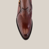 Aerial view of the Francia Rings Tall Shaft Tan - J Toe, a polished brown leather shoe with a pointed toe. It has a smooth texture, subtle stitching, and a dark sole with a slightly raised heel, showcasing premium craftsmanship.