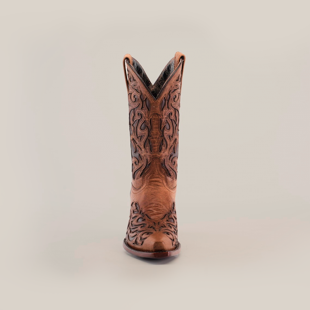 The Trivia Orix womens boot, in premium brown leather with intricate black embroidery, is showcased against a white background. This handcrafted boot features a snip toe and short shaft, highlighting its elegant decorative patterns.