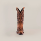 The Trivia Orix womens boot, in premium brown leather with intricate black embroidery, is showcased against a white background. This handcrafted boot features a snip toe and short shaft, highlighting its elegant decorative patterns.