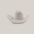 The 1000X Imperial White hat, featuring a pin on the side, is elegantly showcased against a plain light gray background, exuding timeless charm.